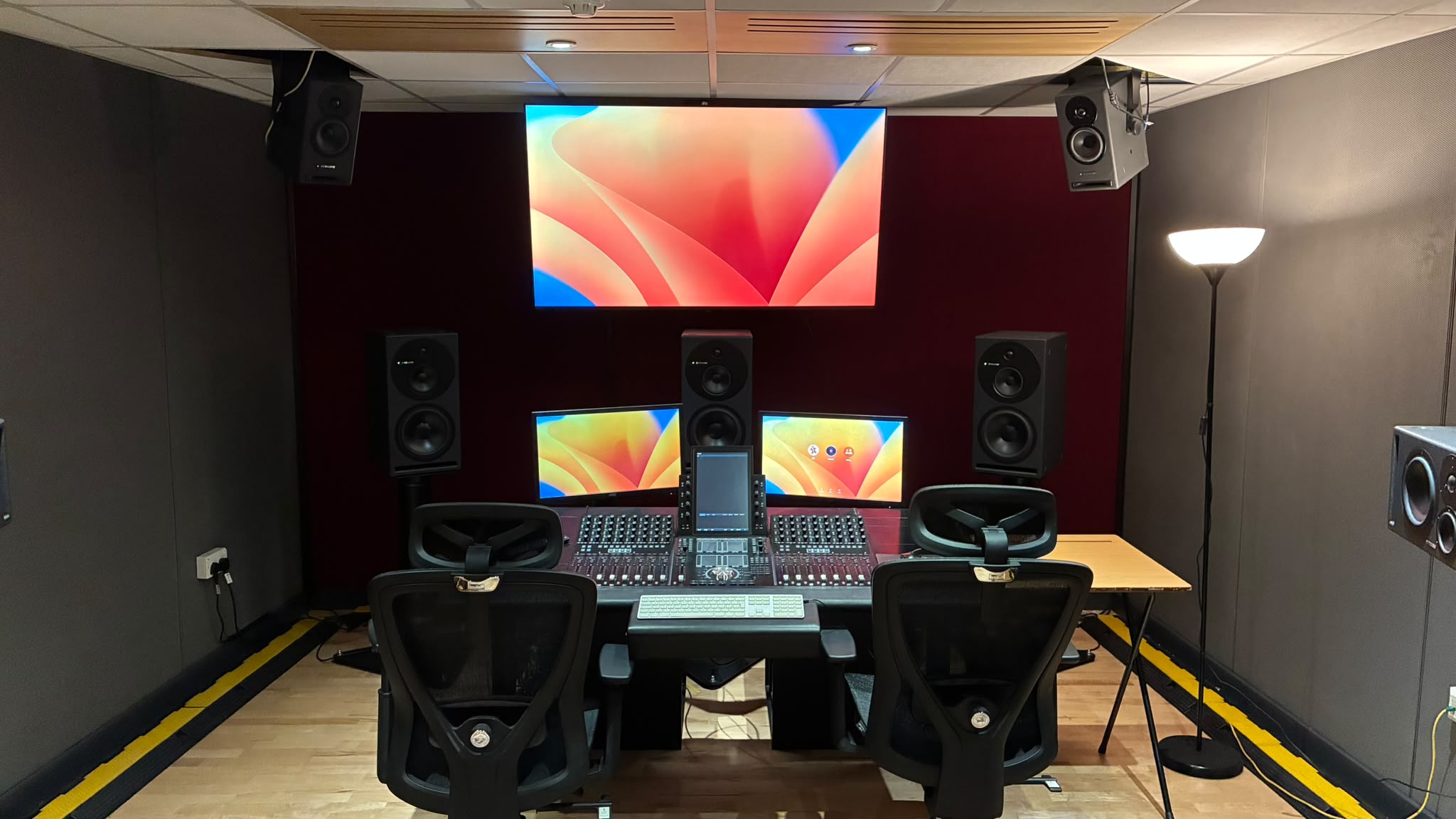 Full frontal view of the Dolby Atmos room and mixing desk.
